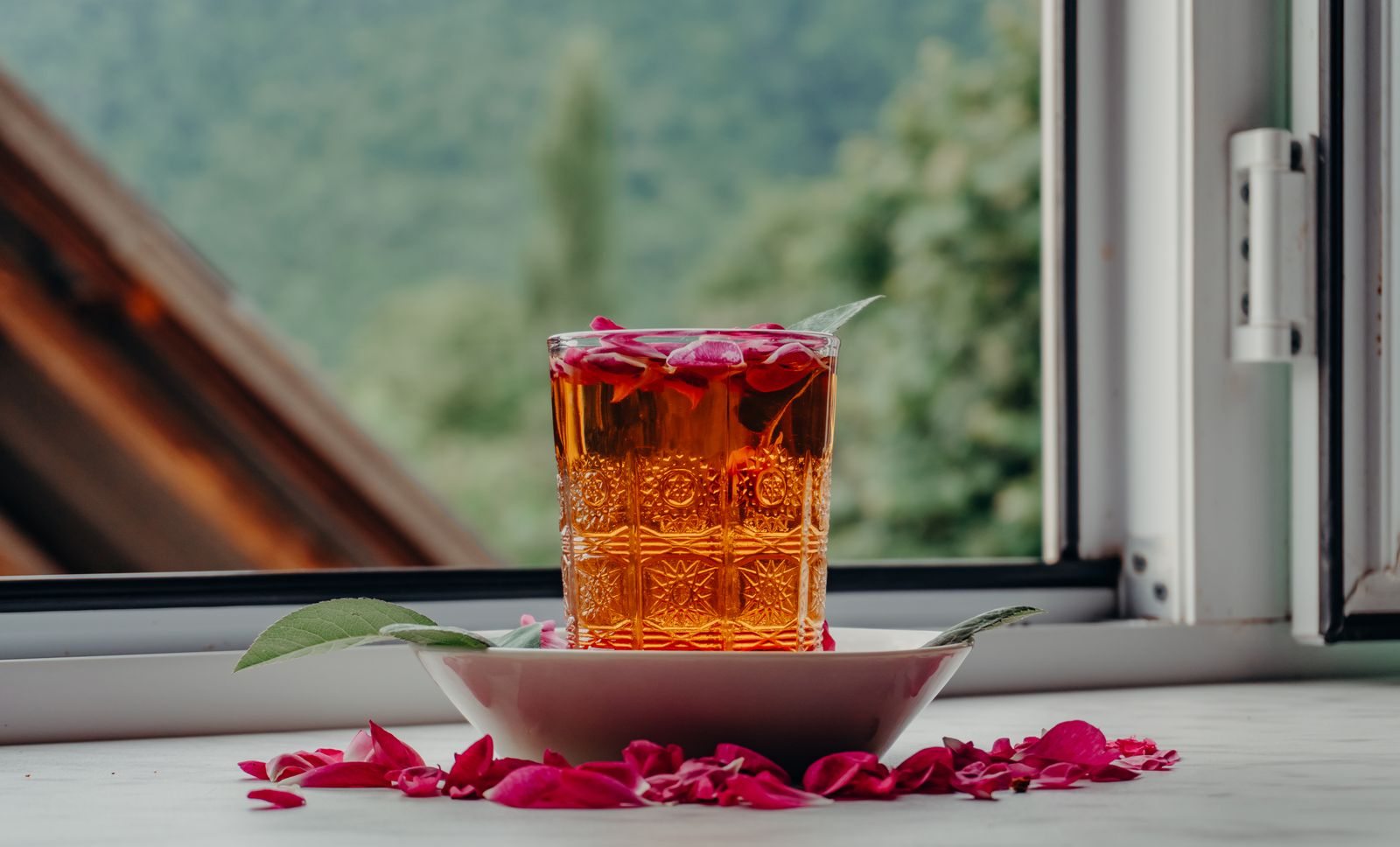 Tea and a book beside a window
