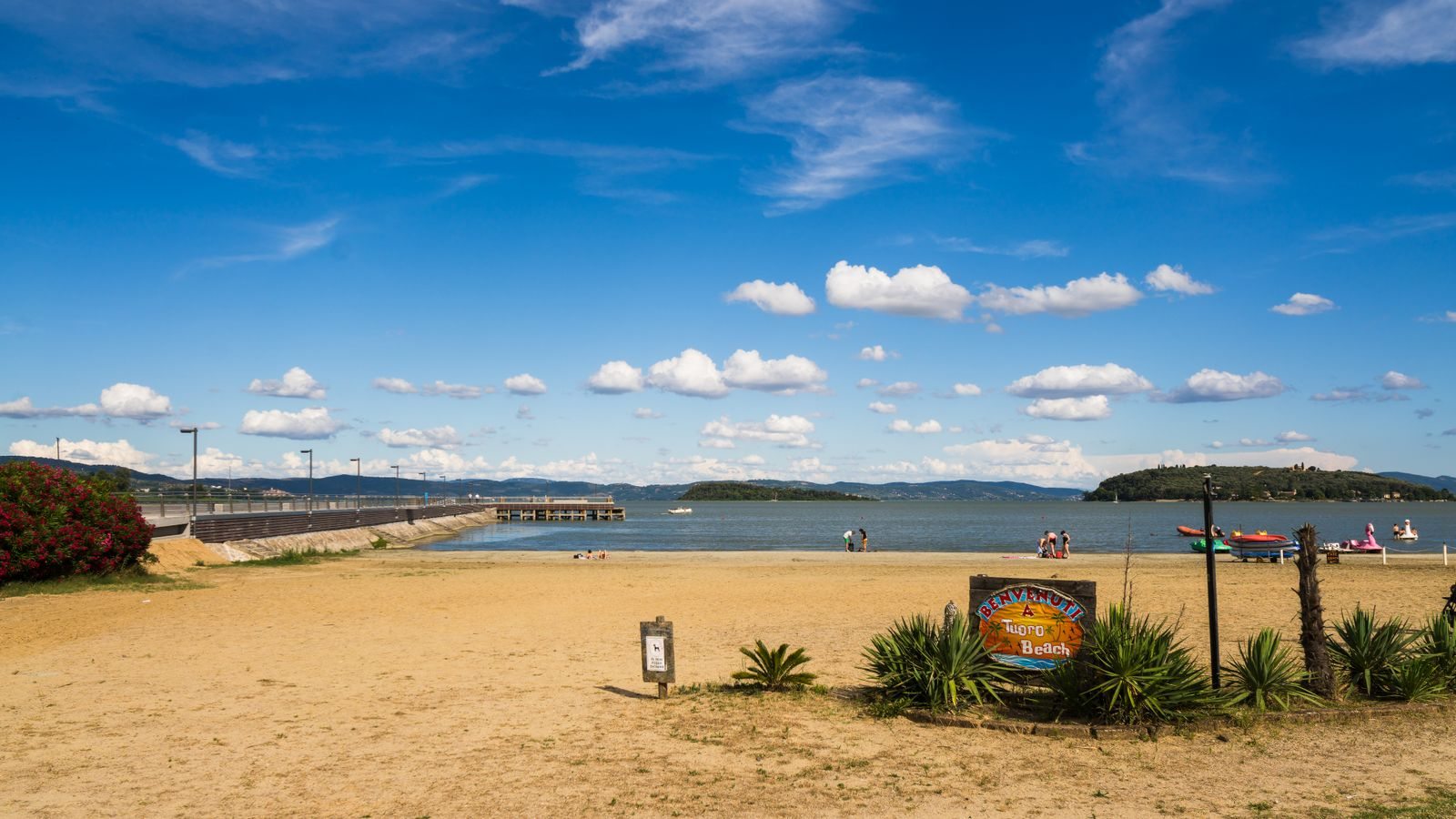 A beach on Lake Trasimeno beneath an open sky